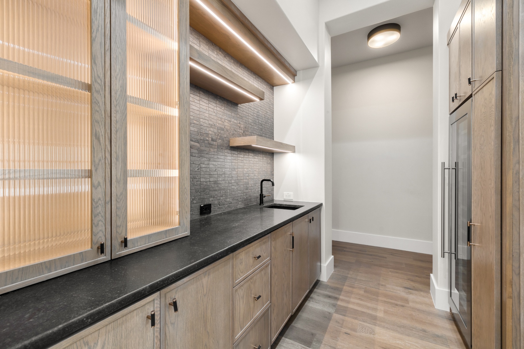 Butler's pantry with stone mosaic backsplash by Amaya