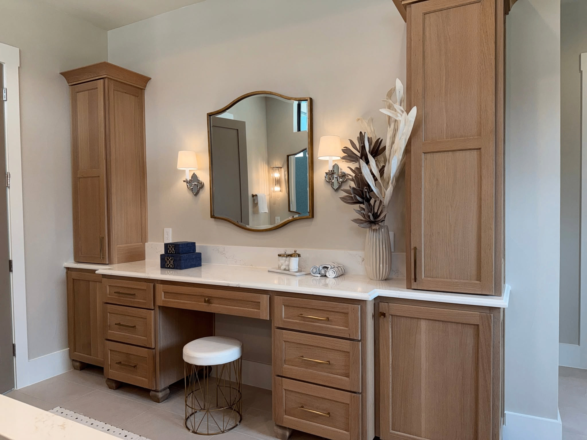 Dark wood bathroom vanity with brass hardware and inset detailing by Amaya